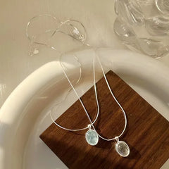 Stylish Simplicity: Silver Oval Aquamarine Pendant Necklace by VOQ