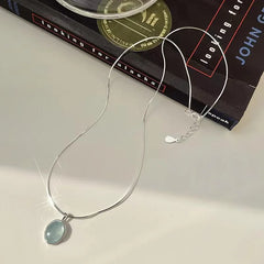 Stylish Simplicity: Silver Oval Aquamarine Pendant Necklace by VOQ